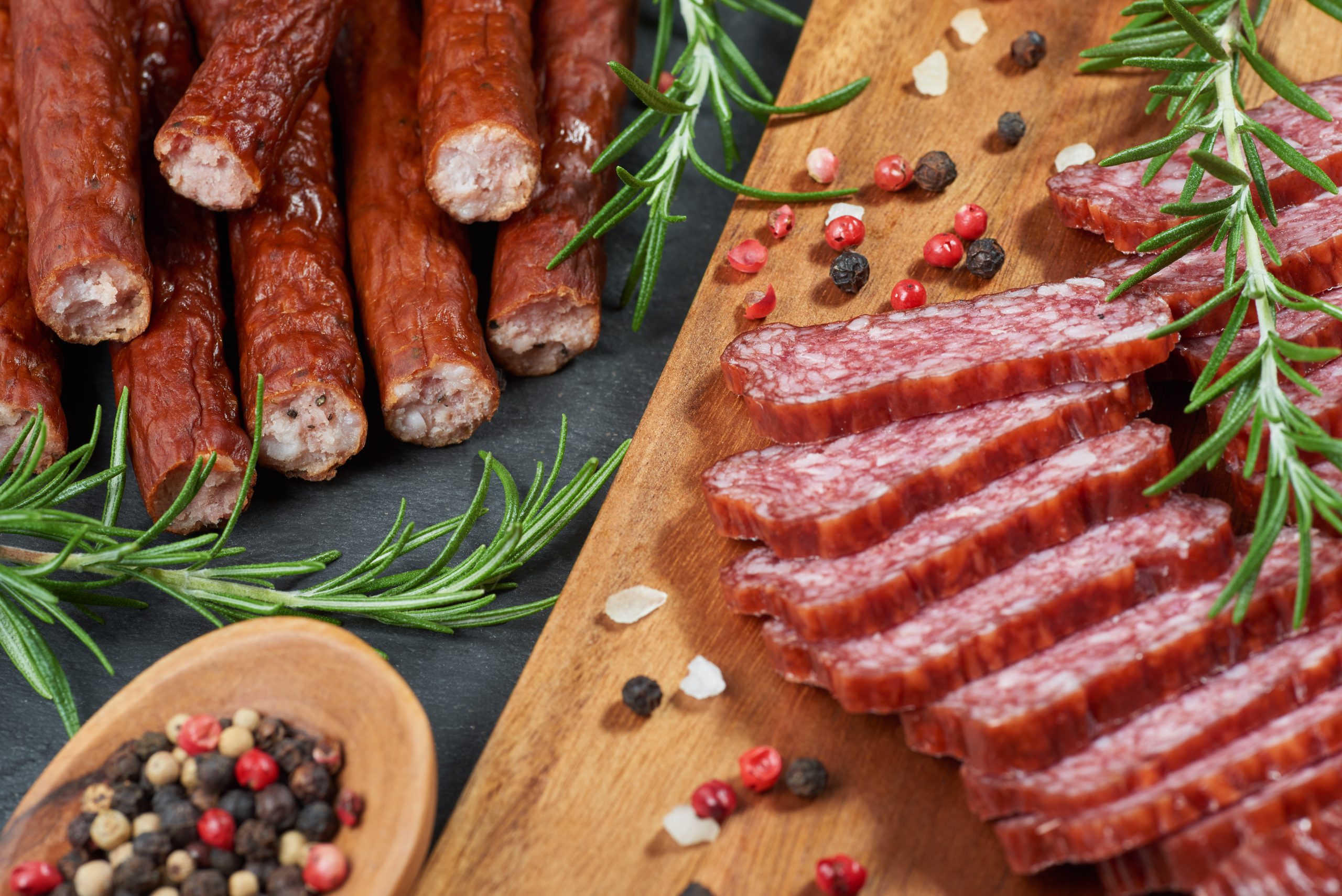 Set of cold cuts on a wooden board. Mix of sausages